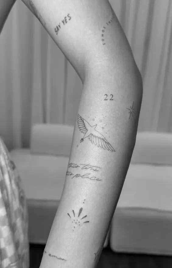 Fine line script tattoo on arm with 'say yes' text by Chelsea.Q